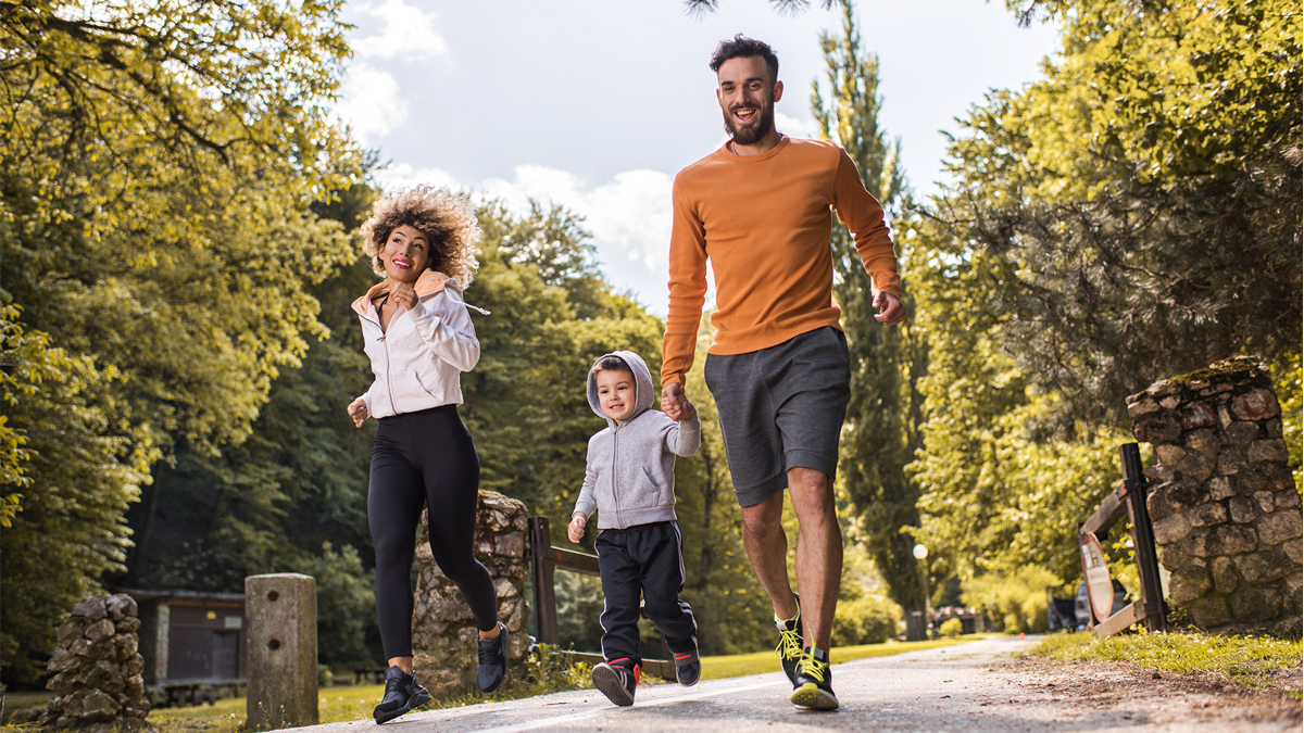 family doing exercise in a park