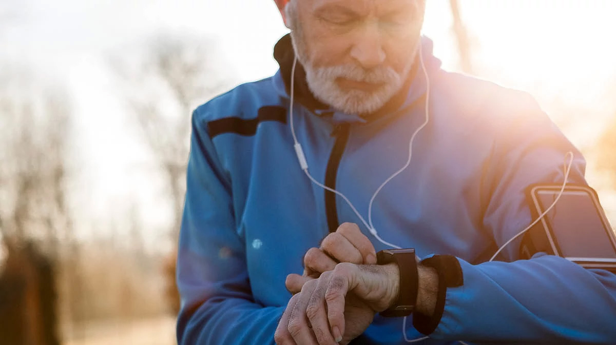 man doing exercise and checking watch